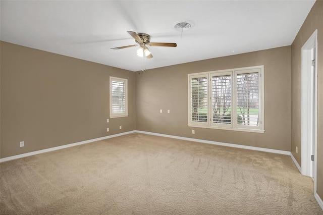 carpeted empty room featuring plenty of natural light and ceiling fan