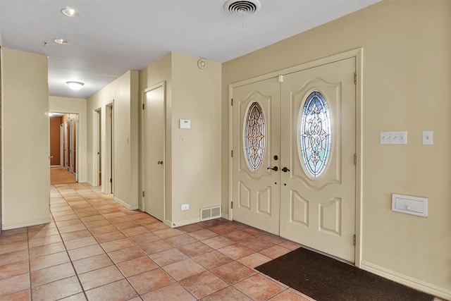 entryway with light tile patterned flooring