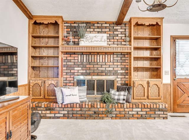 living room with carpet flooring, a textured ceiling, wooden walls, and beamed ceiling