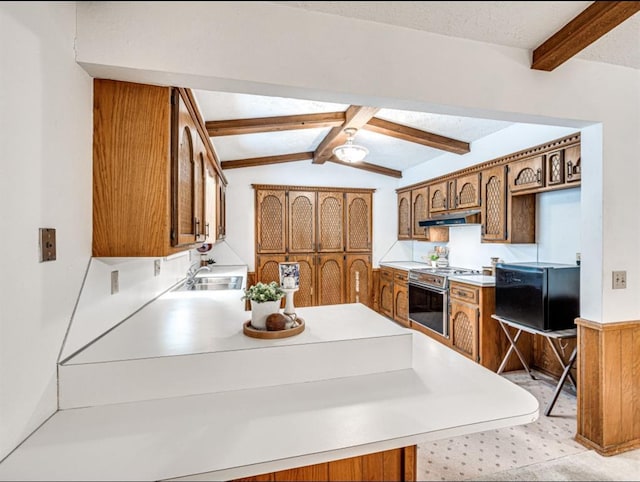 kitchen featuring sink, lofted ceiling with beams, kitchen peninsula, and stainless steel electric range