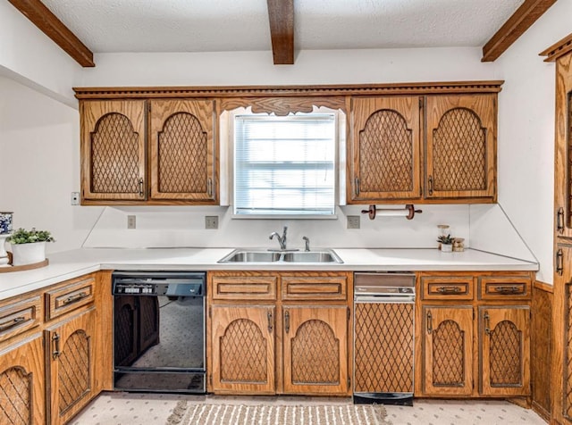 kitchen with a textured ceiling, sink, black dishwasher, and beamed ceiling