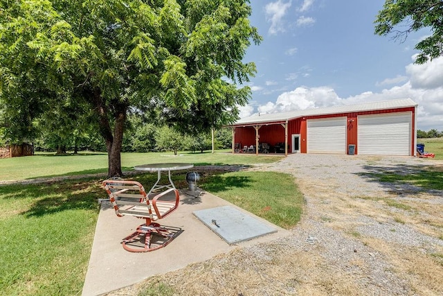 view of yard with a garage and an outdoor structure