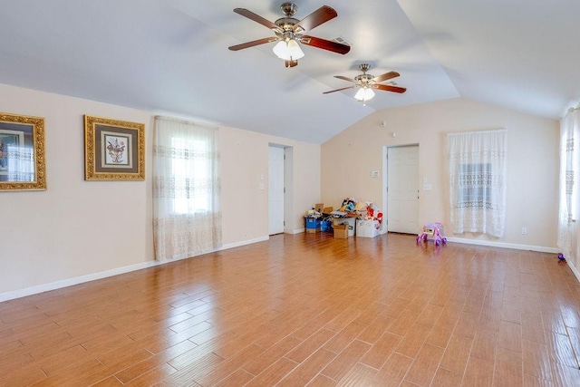 workout area featuring light hardwood / wood-style floors, vaulted ceiling, and ceiling fan