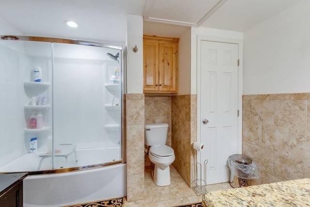 full bathroom with tile patterned flooring, toilet, enclosed tub / shower combo, and tile walls