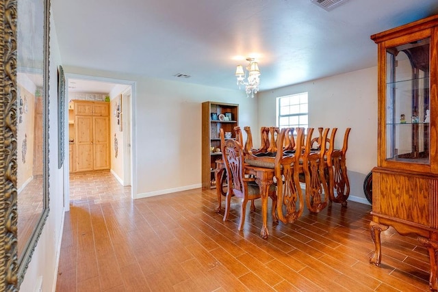 dining room with an inviting chandelier and hardwood / wood-style flooring