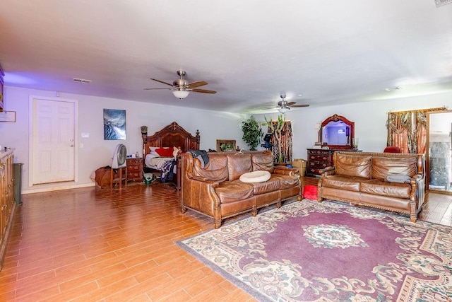 living room with ceiling fan and hardwood / wood-style floors