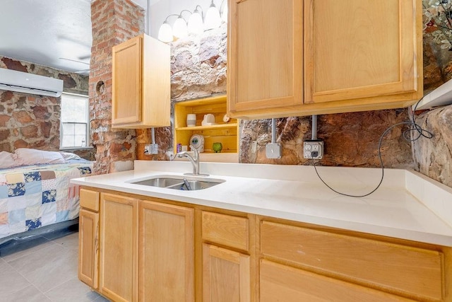 kitchen with sink, a wall unit AC, decorative backsplash, light brown cabinetry, and light tile patterned floors