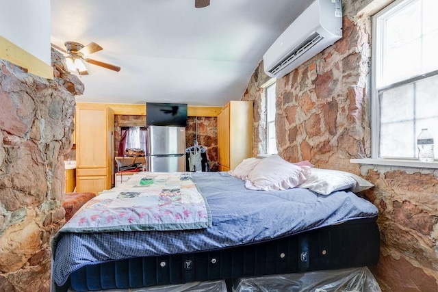 bedroom featuring ceiling fan, stainless steel fridge, and a wall mounted AC