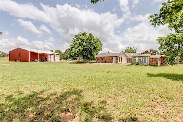 view of yard featuring a garage and an outdoor structure