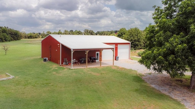 view of outbuilding with a lawn and a garage