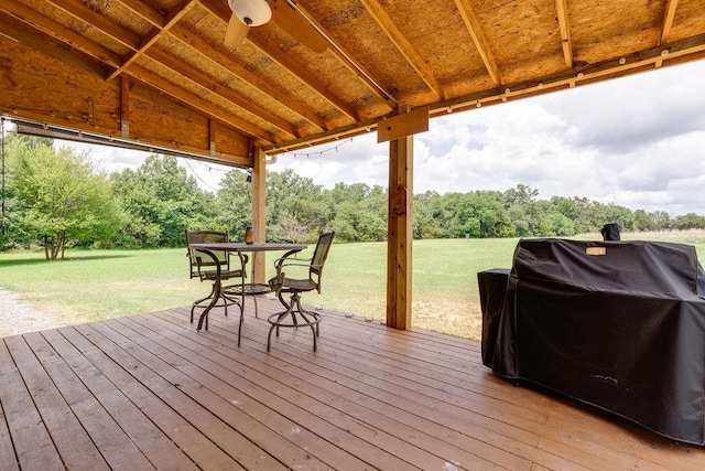 deck with a lawn and area for grilling