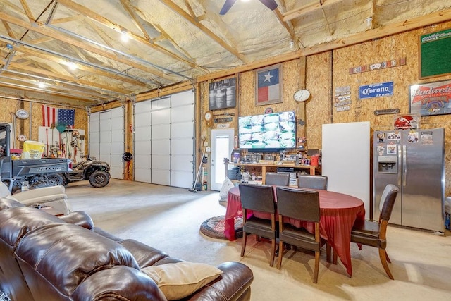 garage with stainless steel fridge with ice dispenser