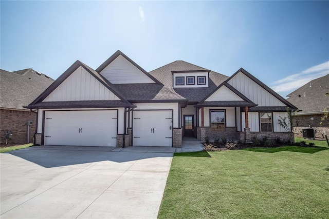 craftsman inspired home with a garage, a front lawn, and central air condition unit