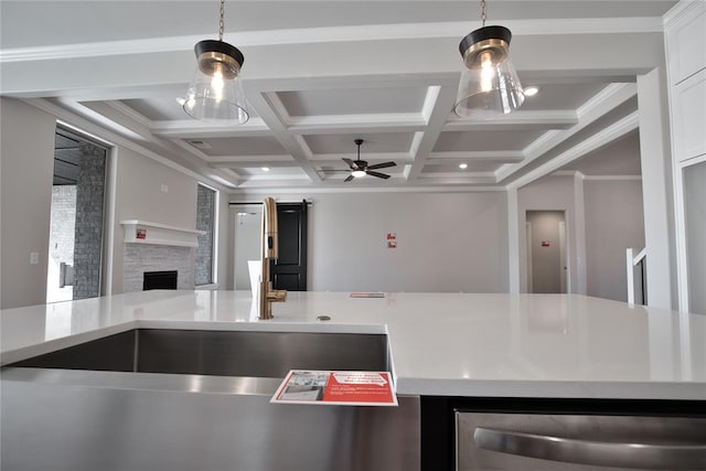 kitchen featuring coffered ceiling, ceiling fan, ornamental molding, a fireplace, and beamed ceiling