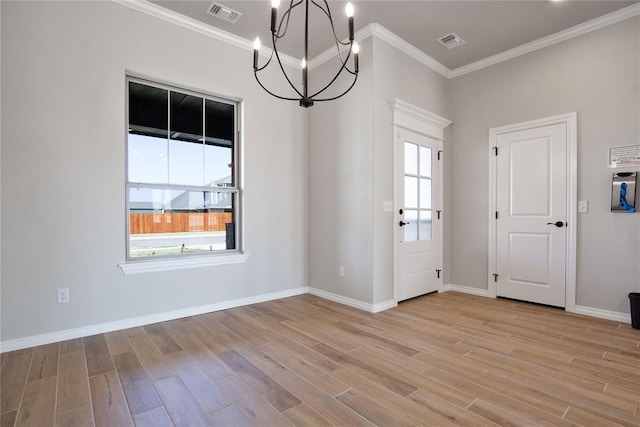 interior space with ornamental molding, light wood-type flooring, and a notable chandelier