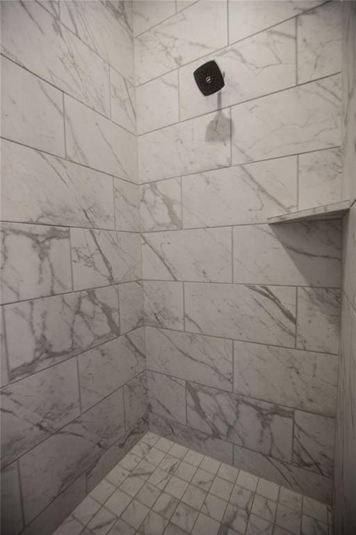 bathroom with a tile shower