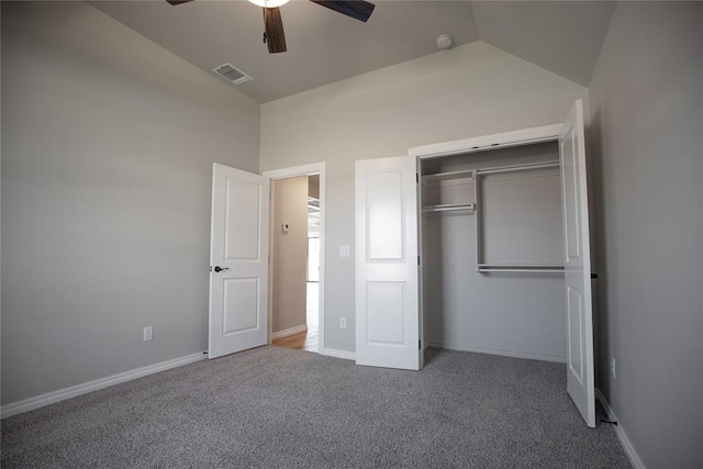 unfurnished bedroom with ceiling fan, a closet, carpet, and vaulted ceiling