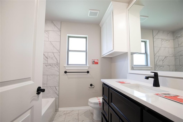 full bathroom featuring vanity, toilet, and tiled shower / bath