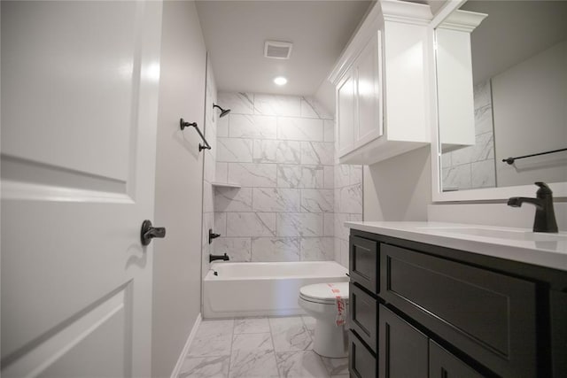 full bathroom with toilet, vanity, and tiled shower / bath