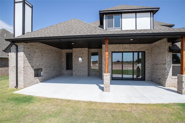 rear view of house featuring a patio area and a lawn