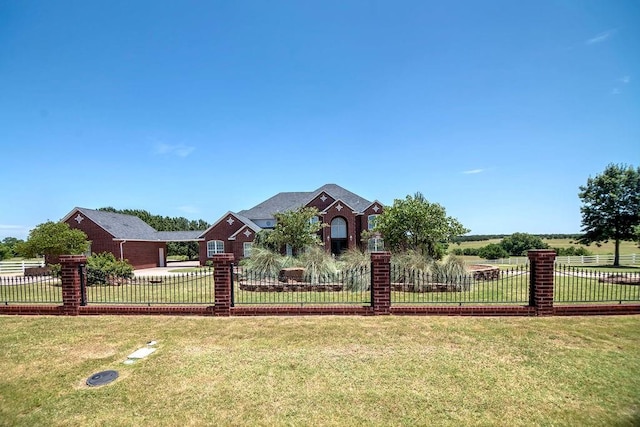 view of front of house with a front yard and a rural view