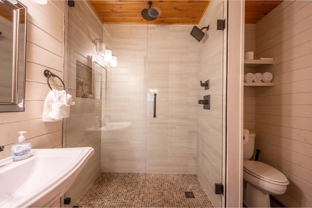 bathroom featuring a shower with shower door, toilet, and wood ceiling