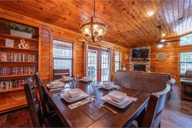 dining area featuring wood walls, wooden ceiling, french doors, vaulted ceiling, and dark hardwood / wood-style flooring