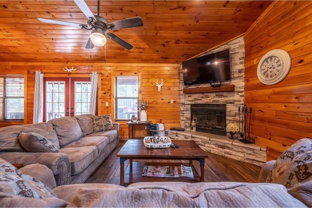 living room with dark wood-type flooring, wooden ceiling, lofted ceiling, wooden walls, and a fireplace