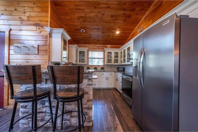 kitchen featuring white cabinetry, stainless steel appliances, wooden ceiling, tasteful backsplash, and dark hardwood / wood-style floors