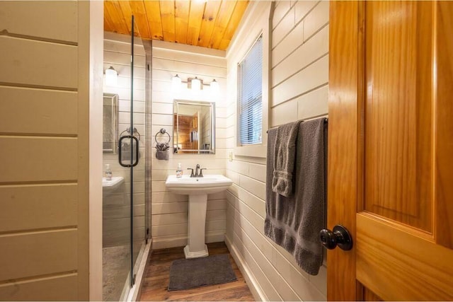 bathroom with sink, hardwood / wood-style floors, wooden ceiling, and walk in shower