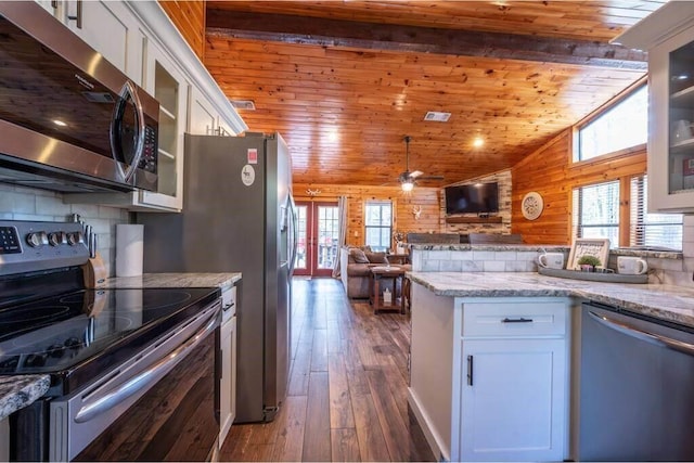 kitchen featuring a wealth of natural light, white cabinets, and stainless steel appliances