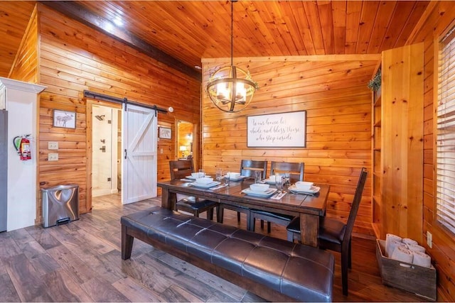 dining room with lofted ceiling, hardwood / wood-style flooring, a barn door, a notable chandelier, and wood ceiling