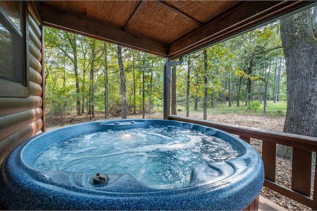 view of swimming pool featuring a hot tub