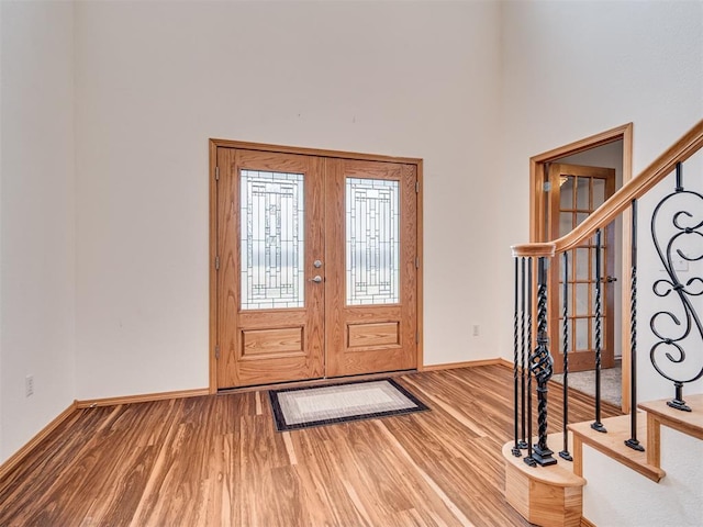 entryway featuring hardwood / wood-style floors and french doors