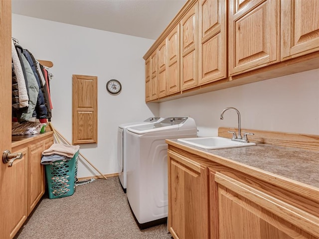 washroom with separate washer and dryer, sink, light colored carpet, and cabinets