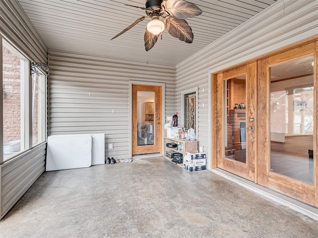 unfurnished sunroom featuring ceiling fan