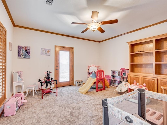 game room with ceiling fan, carpet floors, and ornamental molding