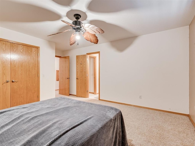 unfurnished bedroom featuring carpet flooring, ceiling fan, and a closet