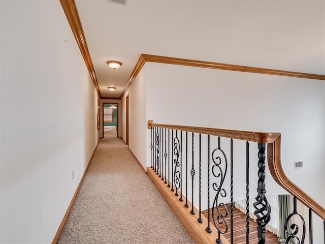 corridor featuring light carpet and crown molding