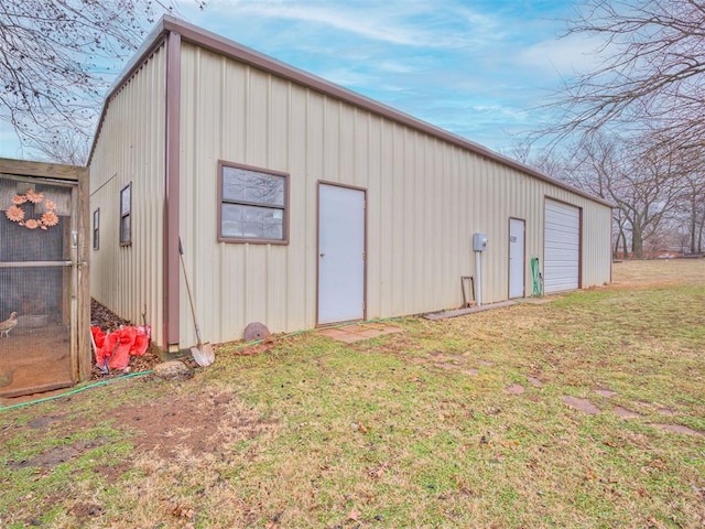 view of outdoor structure with a yard and a garage