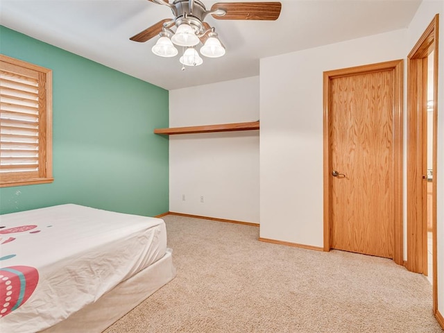 carpeted bedroom featuring ceiling fan