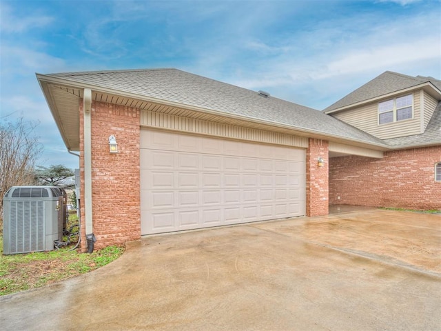 1419 W Royal Oaks Rd, Pauls Valley, OK 73075 - view of front of house featuring roof with shingles, brick siding, and concrete driveway