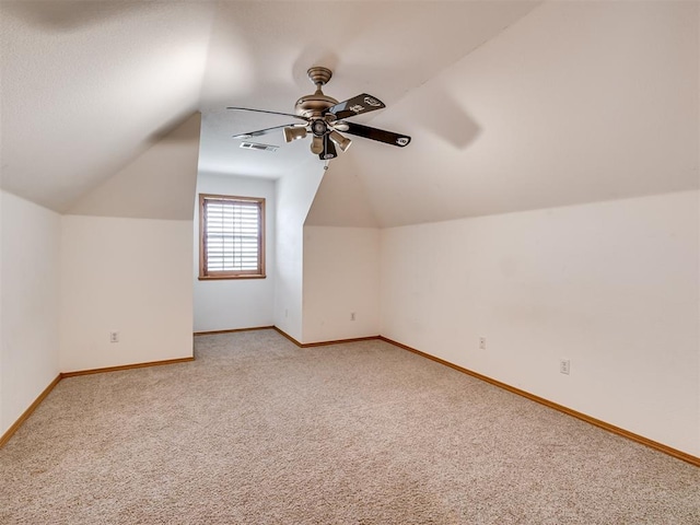 bonus room with carpet flooring, vaulted ceiling, and ceiling fan