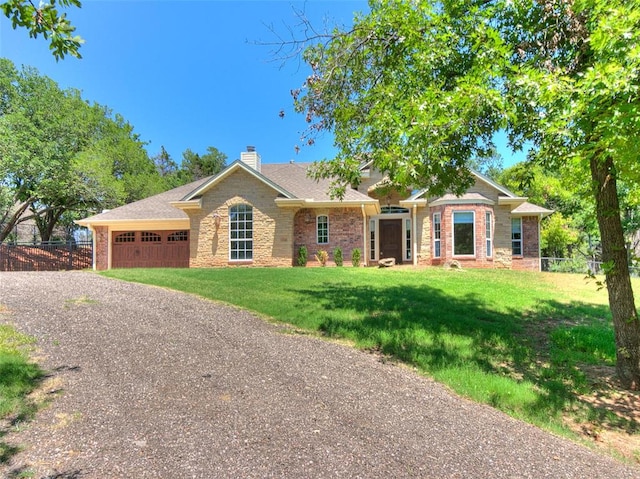 ranch-style house featuring a garage and a front lawn