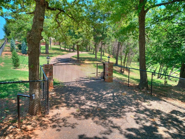 view of gate featuring a yard