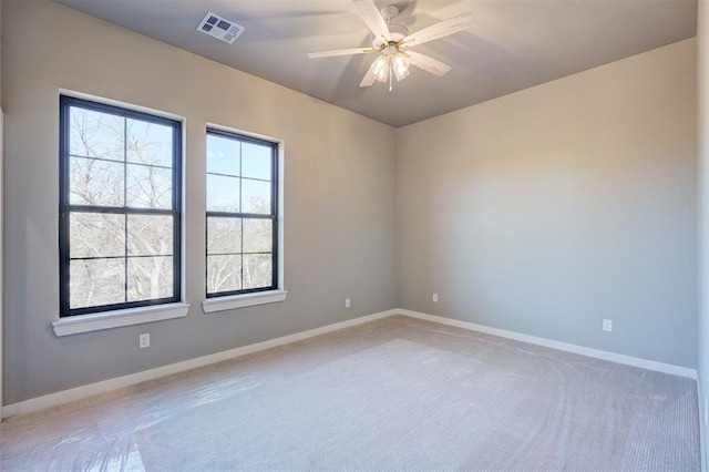 carpeted spare room with ceiling fan