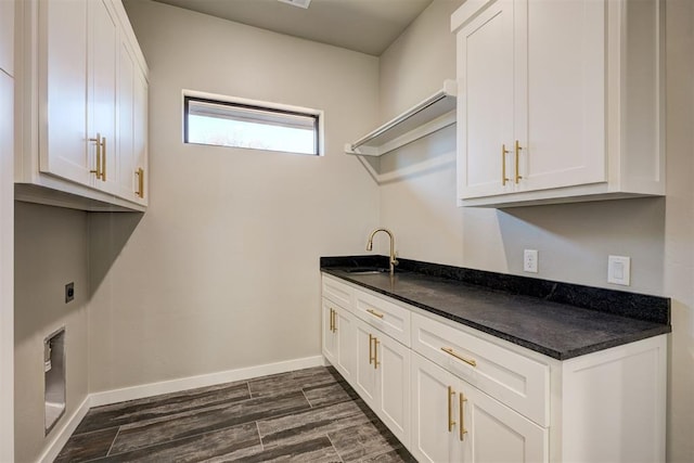 laundry area featuring hookup for an electric dryer, dark hardwood / wood-style flooring, and sink