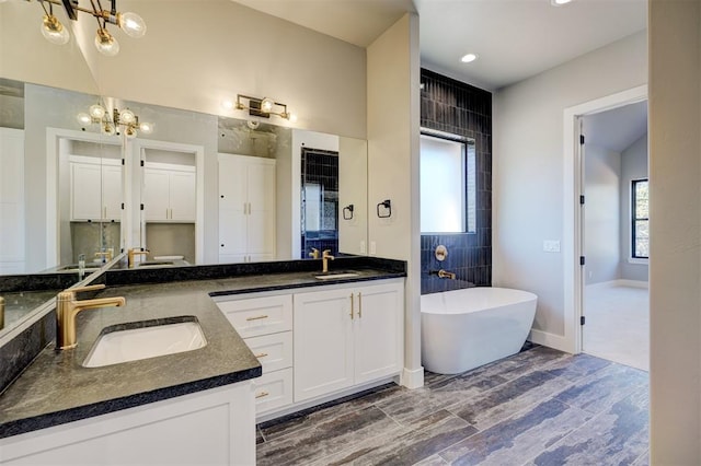 bathroom with vanity and a tub to relax in