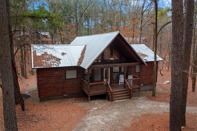 log-style house featuring a porch