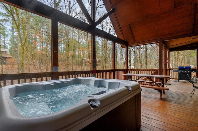 deck featuring grilling area and a hot tub